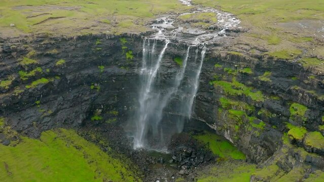 Aerial Panning Slow Motion Beautiful View Of Island Waterfall During Tranquil Weather - Faroe Islands, Denmark