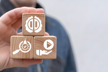 Man holding wooden cubes sees icon: brain with pause. Need to rest the brain business education...