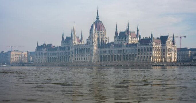 Budapest, Hungary - December 30, 2023: Parliament building in flooded Danube. Time-lapse.