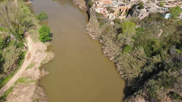 Aerial view of Llobregat river next to abandoned factory. Olesa de Montserrat