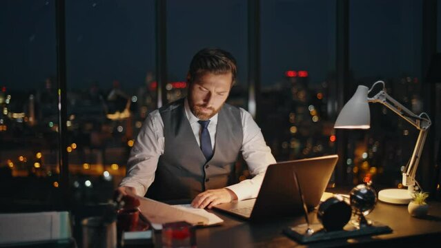 Company man overwork late evening at workplace. Busy worker professional study