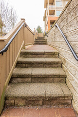 Entrance of painted luxury house with stair steps, green trees and nice landscape in Vancouver, Canada, North America.