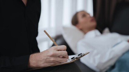 Young female patient lying on crouch release emotion from traumatic event, anxiety or mental illness to psychiatrist during mental treatment therapy in office. Psychological consultation session. Adit