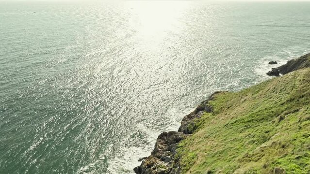 aerial lighthouse reaveal, ocean landscape with a few seagulls flying around the lighthouse