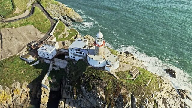 lighthouse on top of a cliff with a few seagulls, Irish landscape, aerial view