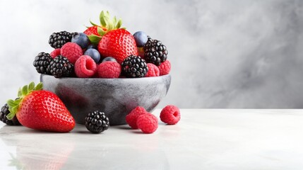 A bowl of mixed berries on a marble surface with room for text.