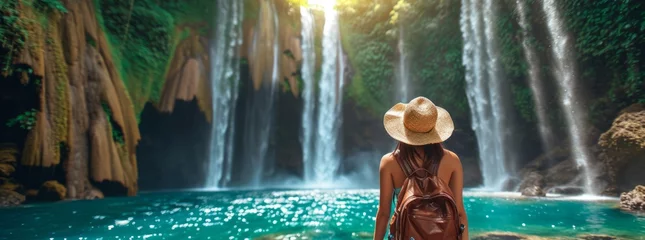 Selbstklebende Fototapeten woman traveler and waterfall © Kittirath