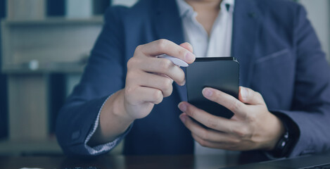 Close up of business people using and check smartphone.