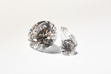 Different beautiful shiny diamonds on white background