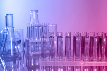 Laboratory glassware with liquid on table. Color toned