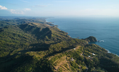 Fototapeta na wymiar Seaside coastline with green hills