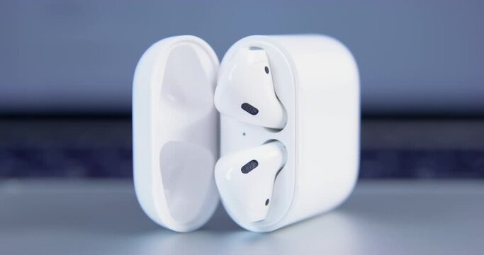 Open case headphones lies side grey reflective surface slow motion aesthetics minimalism brand