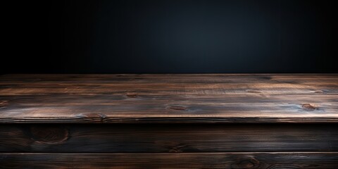 Naklejka na ściany i meble Dark wooden tabletop on black background, suitable for displaying or showcasing your products.