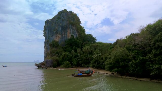 Koh Libong Island Trang province Thailand Andaman Sea. Tropical Island with palm trees and emerald green ocean with longtail boats