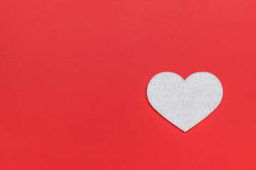 A bright white heart on a red background.
