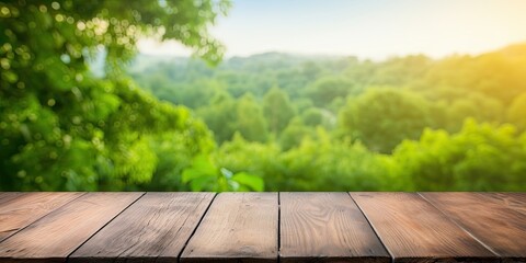 Wooden table surface against green nature backdrop - for montage or showcasing products