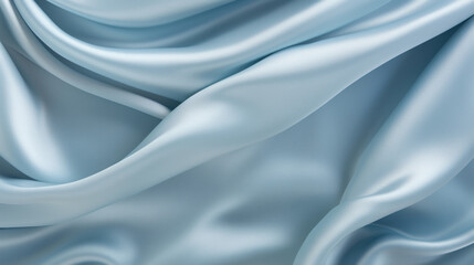 Obraz premium Smooth blue satin fabric draped with grace, highlighting its luxurious texture and sheen for a sophisticated look.