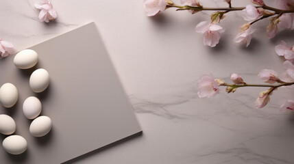 Delicate cherry blossoms alongside a blank grey card, arranged on a textured surface, ideal for spring-themed mockups.