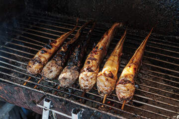 Side dish street food of thailand. Catfish grilled on a charcoal grill original recipe in the local market.