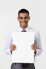Indian man holding up a banner.