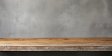 Wood-textured table top on a background of a gray concrete wall.
