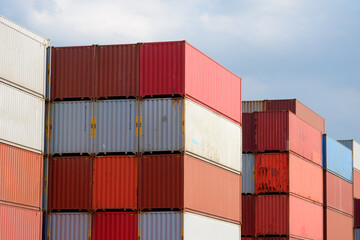Stacks of shipping containers, import/export ships in seaports, industrial shipping freight, container logistics, maritime transport, distribution yard, commercial port business and transportation.