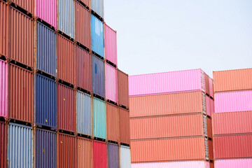 Fototapeta premium Stacks of shipping containers, import/export ships in seaports, industrial shipping freight, container logistics, maritime transport, distribution yard, commercial port business and transportation.