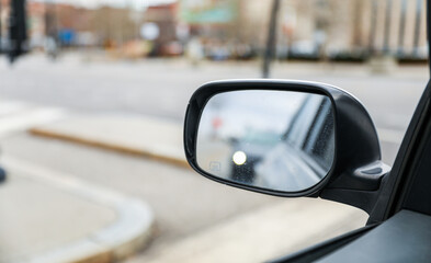 car mirror reflecting past, present, and future, symbolizing the journey of life and the pursuit of...