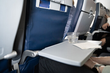 Airplane Travel, Complimentary Drink for Business Trip, Plane Seat, Tray Table. Flying