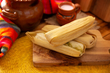 Fototapeta na wymiar Tamales. hispanic dish typical of Mexico and some Latin American countries. Corn dough wrapped in corn leaves. The tamales are steamed.
