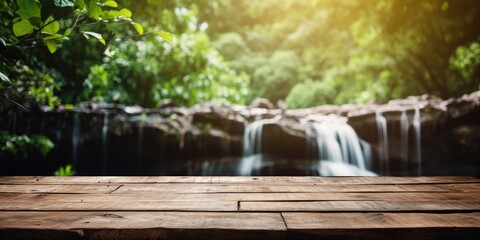 Wooden table and nature background with a waterfall
