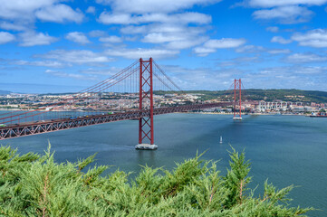 The 25 de Abril Bridge [Ponte 25 de Abril (25th of April Bridge)] connecting the city of Lisbon to the city of Almada over the Tagus River.