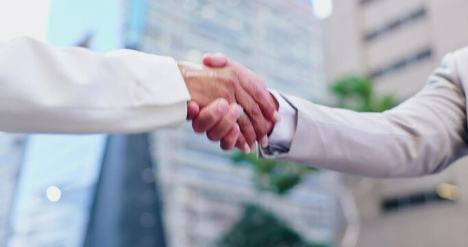 Handshake, partnership and business people in city, agreement and collaboration with support and trust. Meeting, introduction and team for corporate deal, networking and shaking hands outdoor