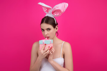 Obraz na płótnie Canvas Close up photo of pretty girl wear easter fluffy bunny ears hold easter eggs, isolated studio background. Eater portrait of female bunny.