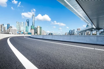 Fototapeten Asphalt highway road and pedestrian bridge with modern city buildings scenery in Shanghai © ABCDstock