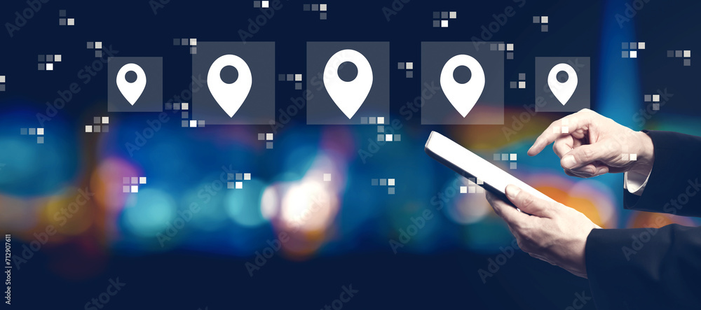 Poster map pin concept with businessman using a tablet computer at night