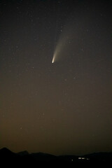 NEOWISE Comet above lake low above horizon