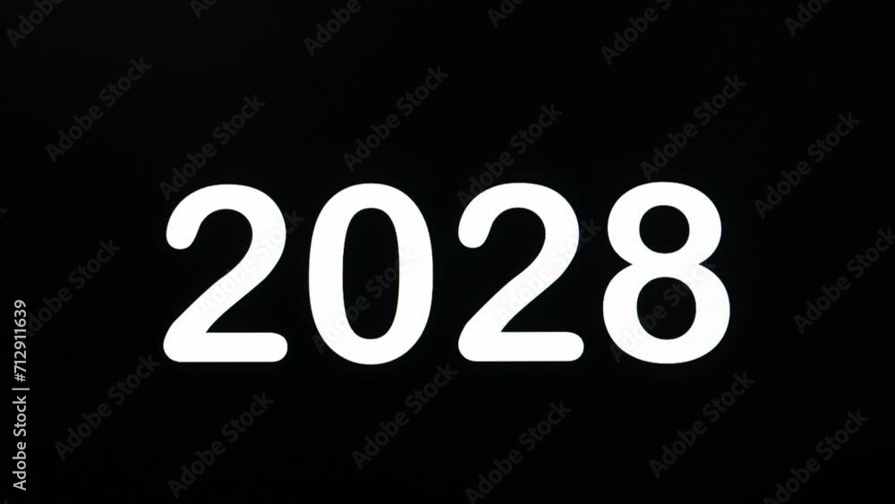 Poster close up of 2028 being typed into computer monitor screen with blinking cursor on black background c