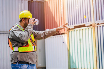 Fototapeta na wymiar Worker Using VR Vision Pro Technology Equipment Headset Device Work at Container Yard Construction site Innovation in Logistics Industry