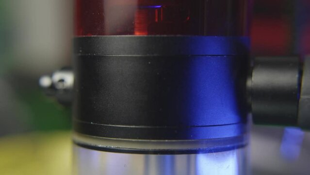 tilt down to reveal the chamber of a water bong for marijuana filling with smoke as the chamber bubbles as someone takes a hit