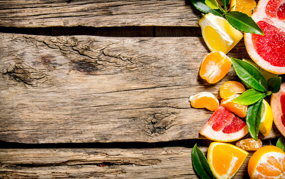 Sliced citrus - grapefruit, orange, tangerine, lemon, lime  with leaves.
