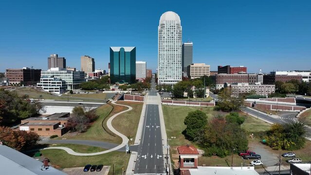 Winston-Salem skyline on bright day. Aerial establishing shot of large North Carolina city.