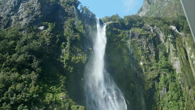 Nature's cascade: Moving down waterfall at Milford Sound in captivating stock footage. A mesmerizing journey through liquid grace.
