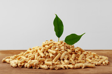 Heap of wooden pellets biofuel on wooden table