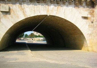 Arch under the bridge on the Seine river in summer in Paris, France