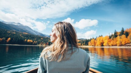 Fototapeta premium Serene Autumn Lake Scene with Contemplative Woman