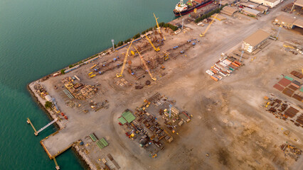 The company assembles large drilling rig structures next to the sea for easy transport onto ships....