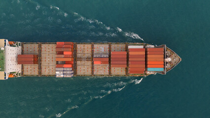 Aerial view of Cargo Container Ship at sunrise. container ship running out of cargo shipyard sea port. export shipping industry freight and transportation logistics concept. commercial shipping by sea