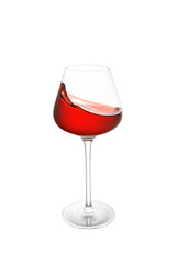Close-up of red wine splashing on table against white background