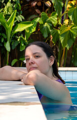 Portrait of young woman in the pool